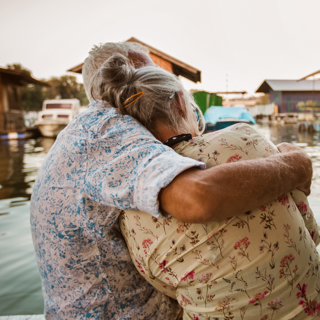 Couple hugging on dock – 1