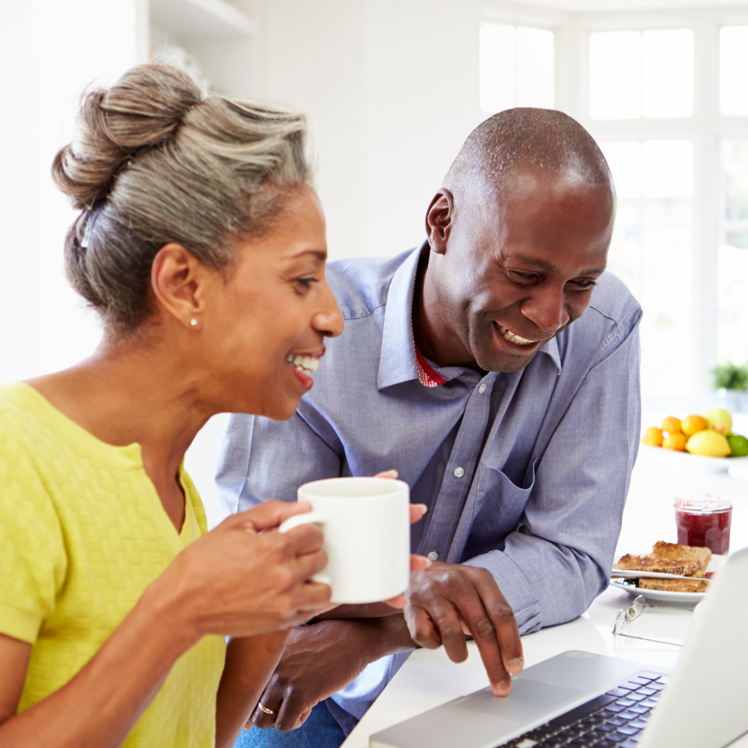 Couple looking at computer in kitchen – 1