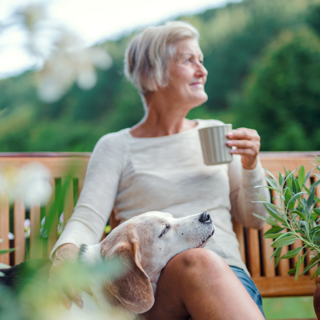 Woman drinking coffee with dog outside – 1