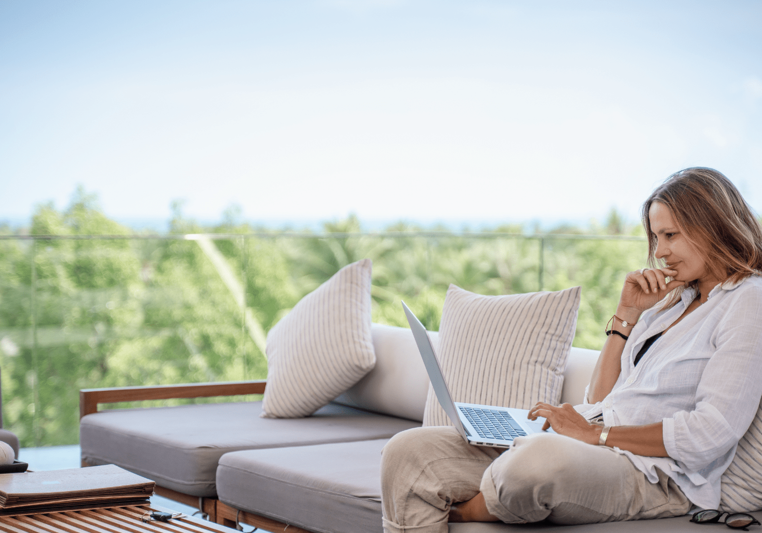 Woman looking at laptop on patio