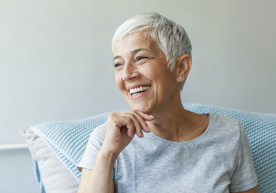 Woman on couch smiling – 1