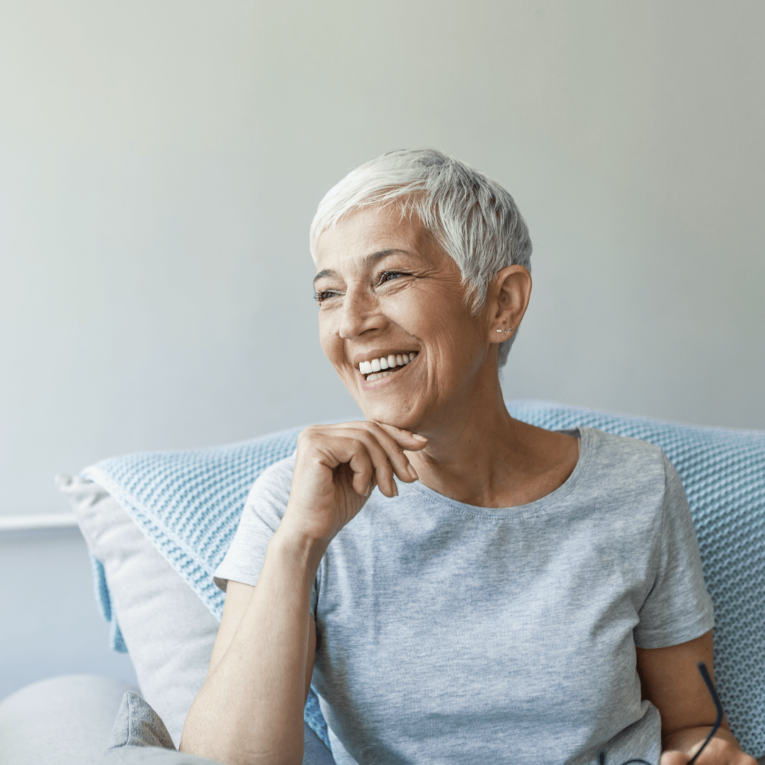 Woman on couch smiling – 1