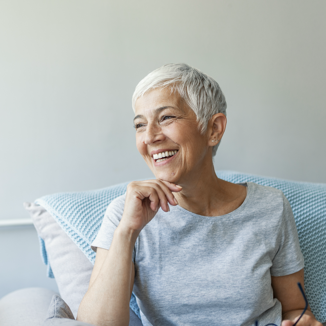 Woman on couch smiling – 1